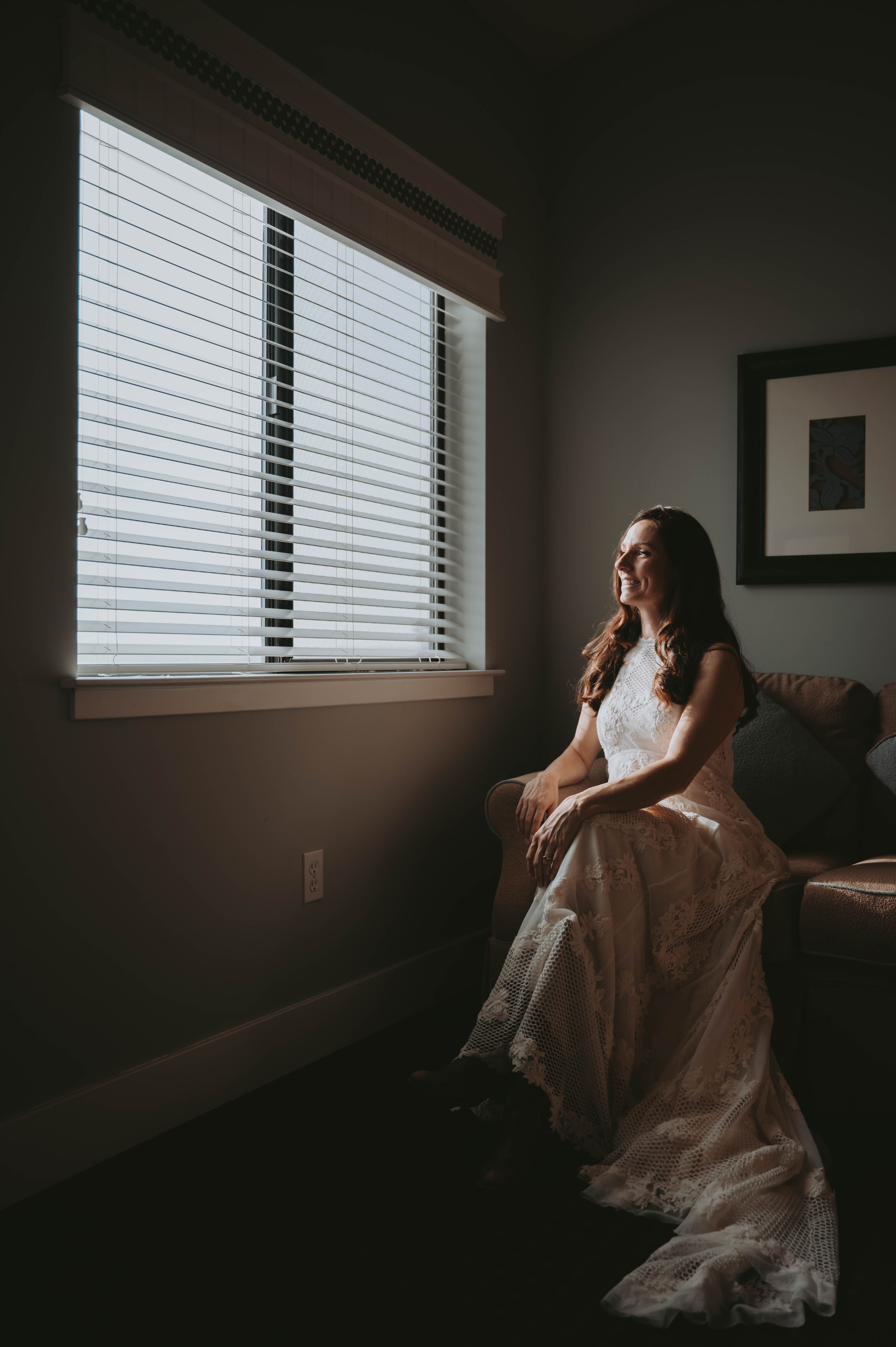 Woman in a Wedding Dress Sitting on a Sofa · Free Stock Photo