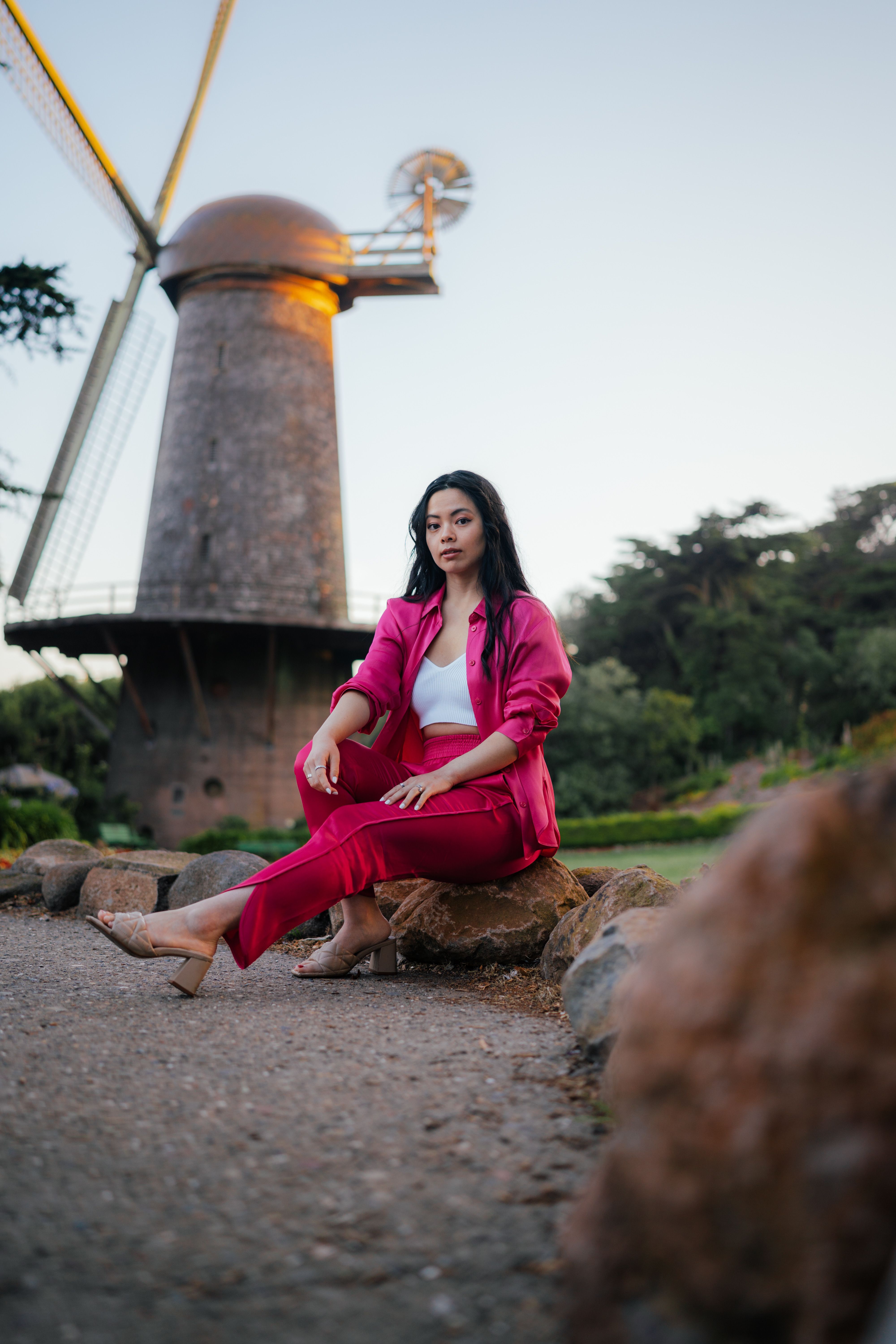 Woman in Black Dress Sitting on Rocks · Free Stock Photo