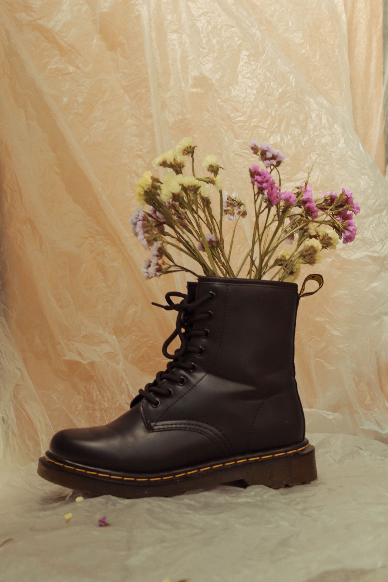 Black platform combat boot styled with flowers