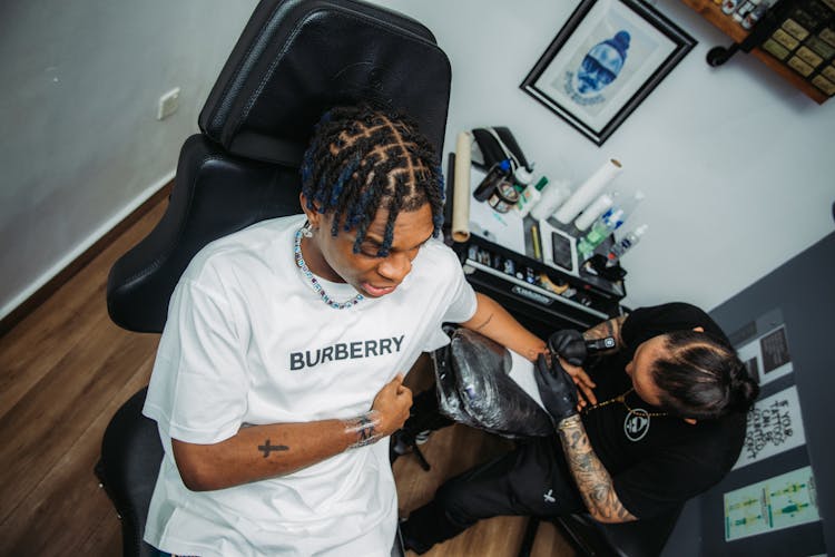 Man Sitting In A Tattoo Chair