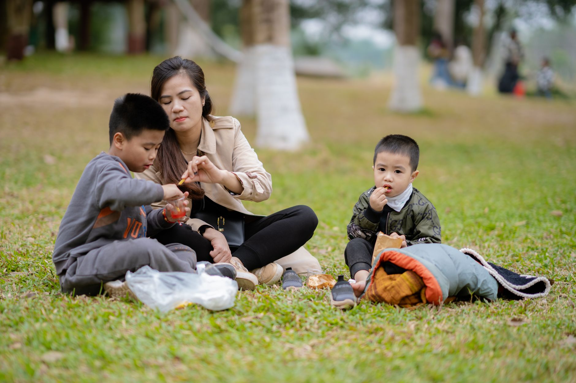 korean family picnic blanket children snacks outdoor