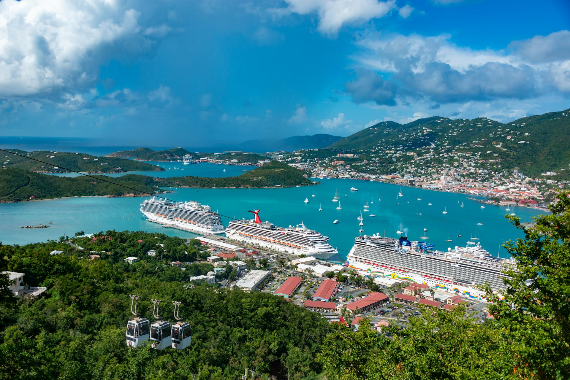 Aerial view of cruise ships docked in Charlotte Amalie Bay, Virgin Islands, under blue skies.