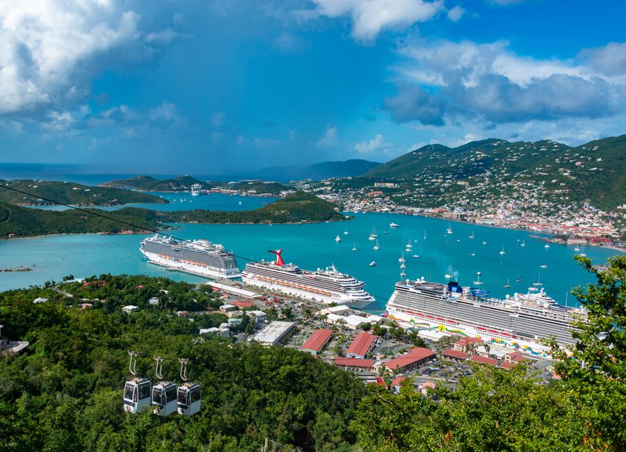 Aerial view of cruise ships docked in Charlotte Amalie Bay, Virgin Islands, under blue skies.