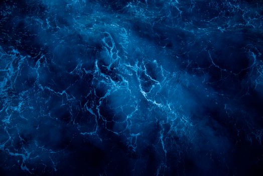 A breathtaking aerial view of deep blue ocean waves showcasing natural beauty and dynamic water patterns.