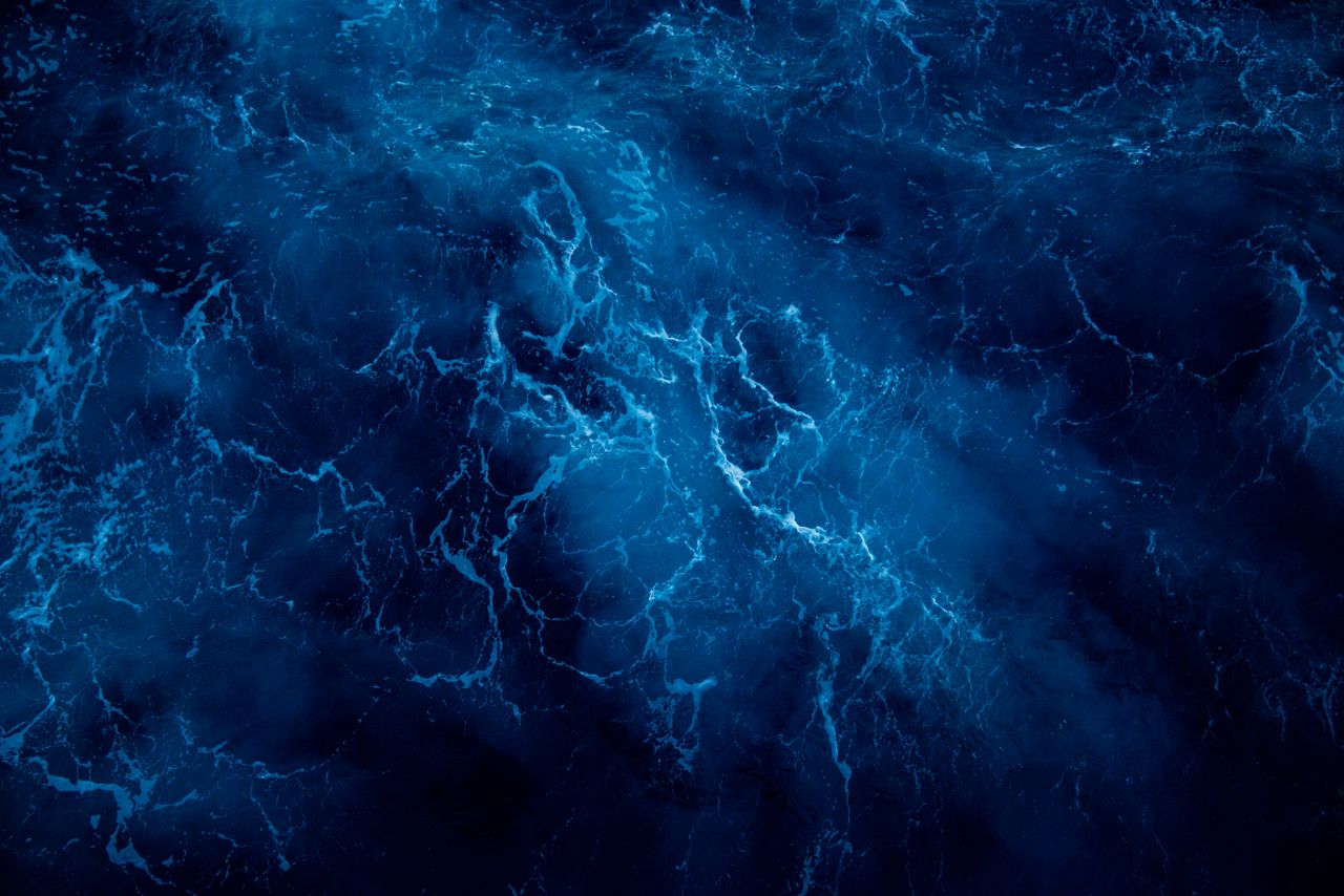a breathtaking aerial view of deep blue ocean waves showcasing natural