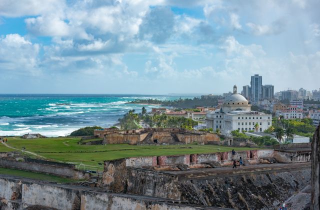 Explore the stunning view of San Juan's historic fort with ocean backdrop under a vibrant sky. — arriving in San Juan