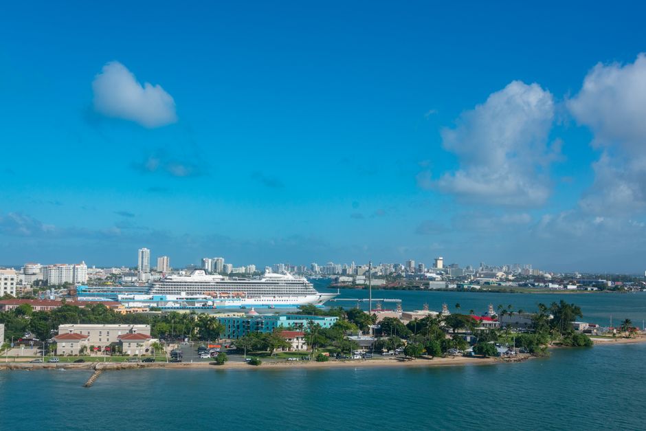 Outstanding Private 60 Minute Romantic Excursion Air Tour with Champagne Review: Miami's Most Unforgettable Couples Experience Review 2026 - Aerial view of a cruise ship moored at a coastal city with a clear blue sky. Ideal for travel and tourism themes.