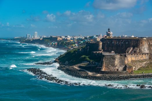 Scenic view of El Morro fortress and vibrant San Juan coastline, Puerto Rico.