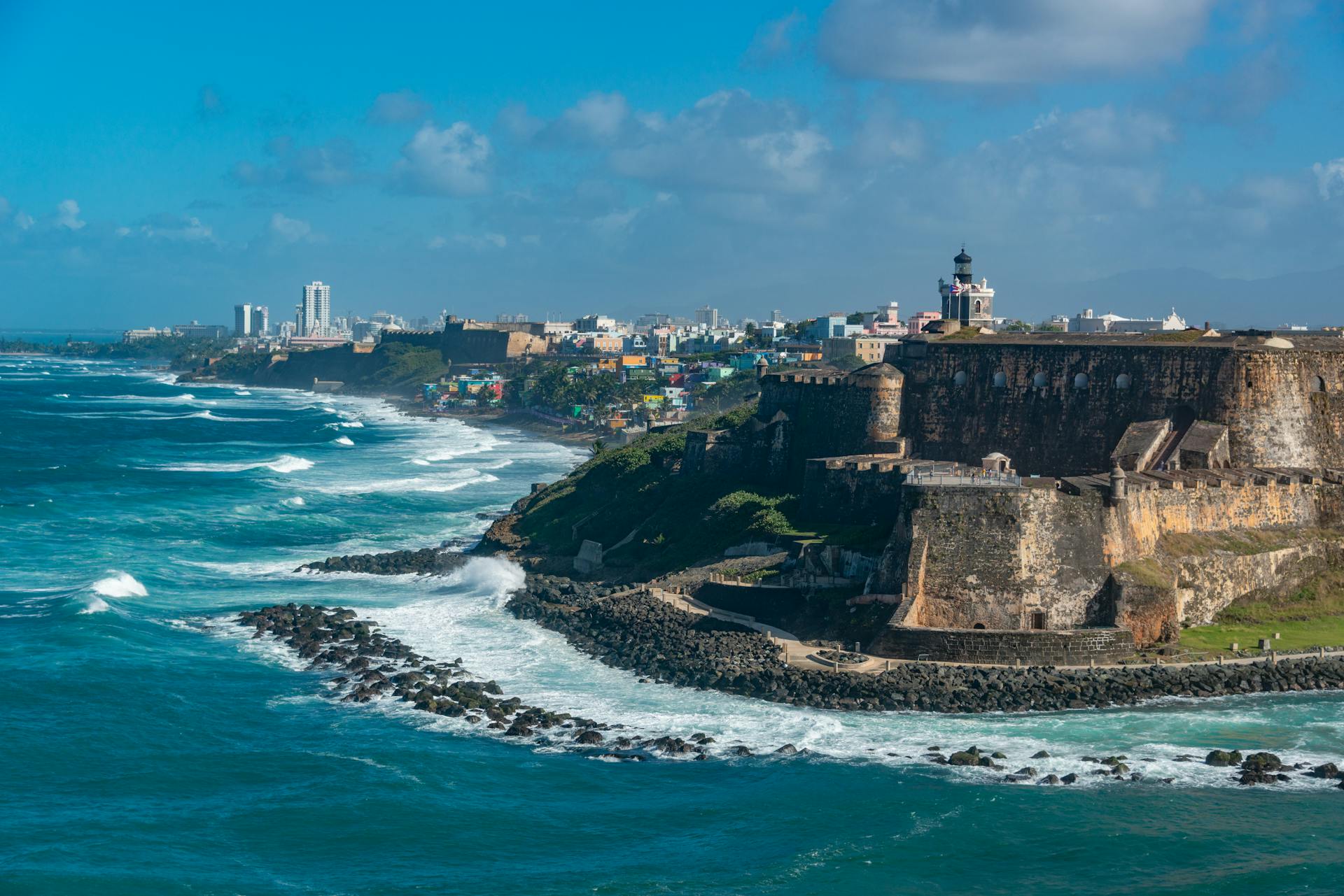 Scenic view of El Morro fortress and vibrant San Juan coastline, Puerto Rico.