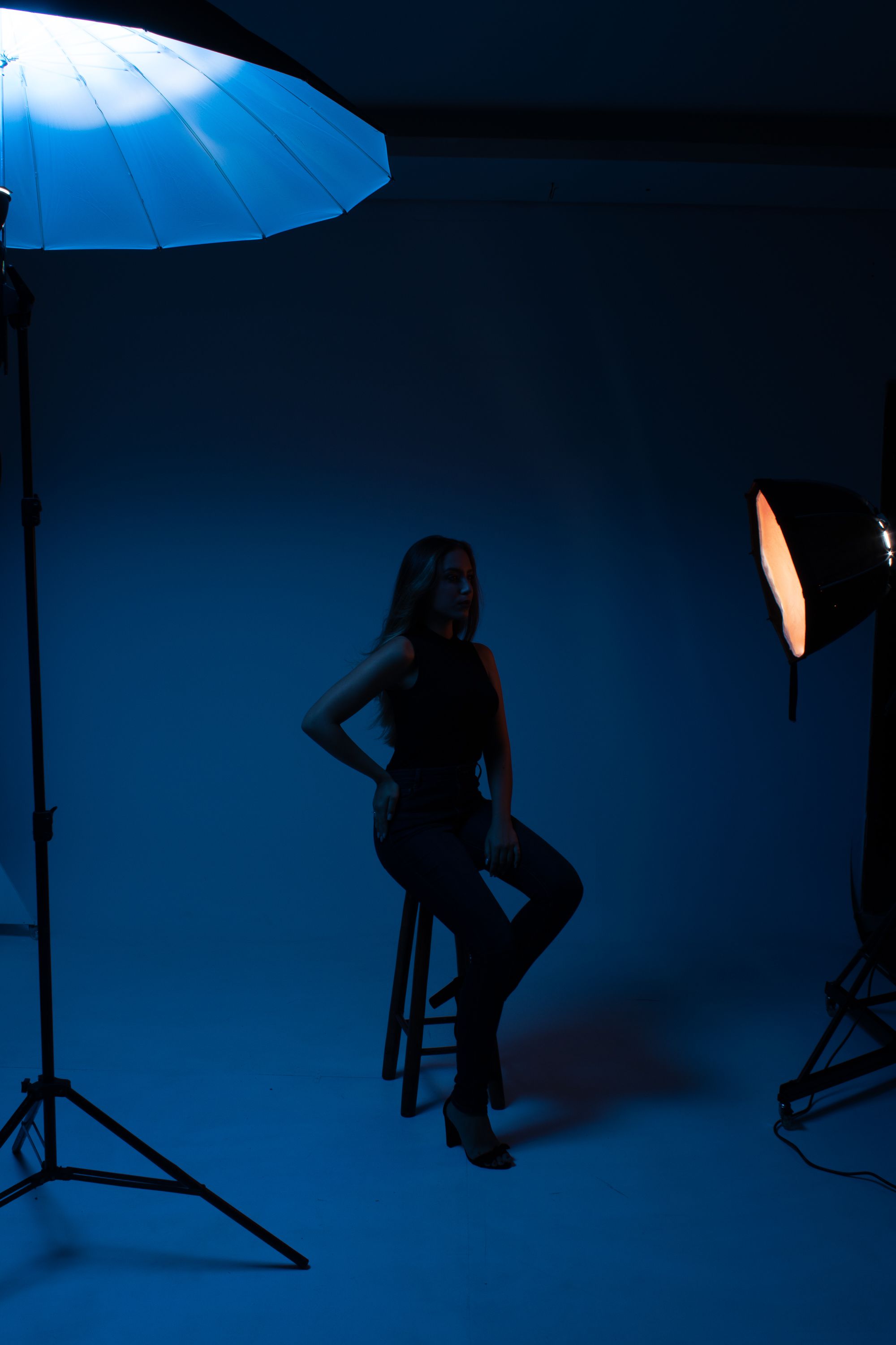 Moody studio portrait of a woman in shadowy lighting, evoking a dramatic and artistic style.. pexels, moody, studio