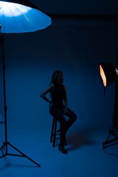 Moody studio portrait of a woman in shadowy lighting, evoking a dramatic and artistic style.. pexels, moody, studio