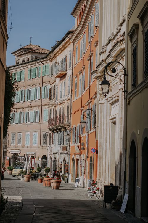 Free Sunlit street with colorful facades in a historic European town, showcasing classic architecture and vibrant atmosphere. Stock Photo