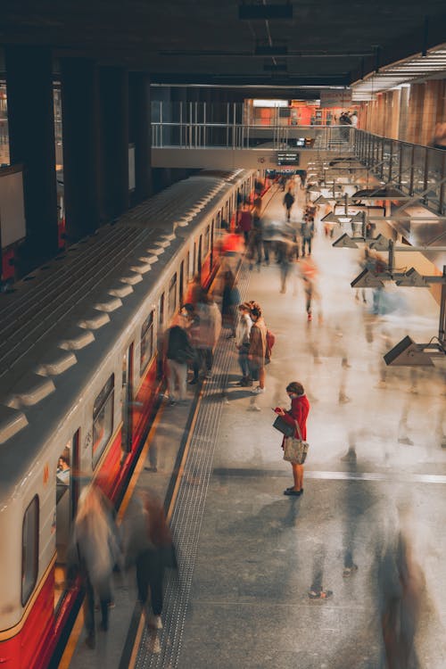 Long Exposure Photo of People Walking on a Subway Station Platform 
