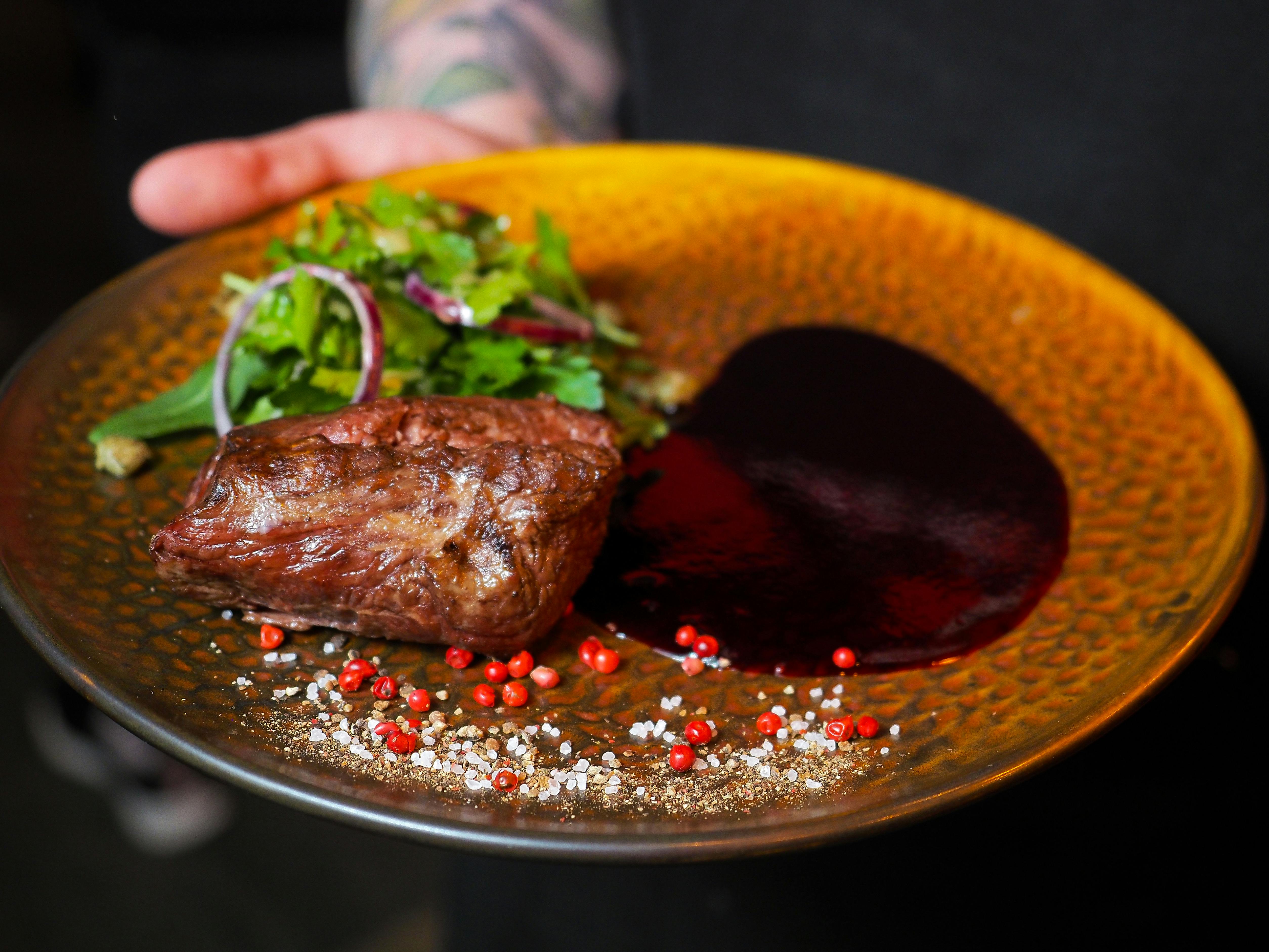 a person holding a plated dish