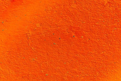 Free Close-up of a bright orange rough textured wall with ample copy space. Stock Photo