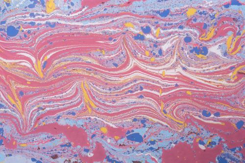 Free Colorful swirls of pink, blue, and yellow in a vibrant abstract paint design. Stock Photo