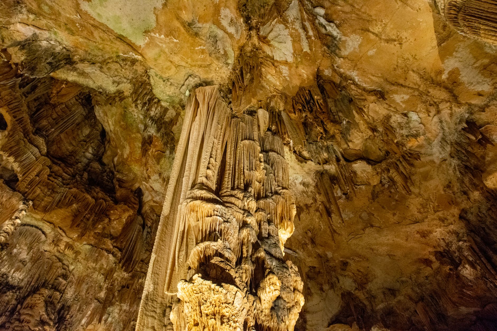 Explore stunning geological formations inside a natural cave with stalactites and stalagmites.