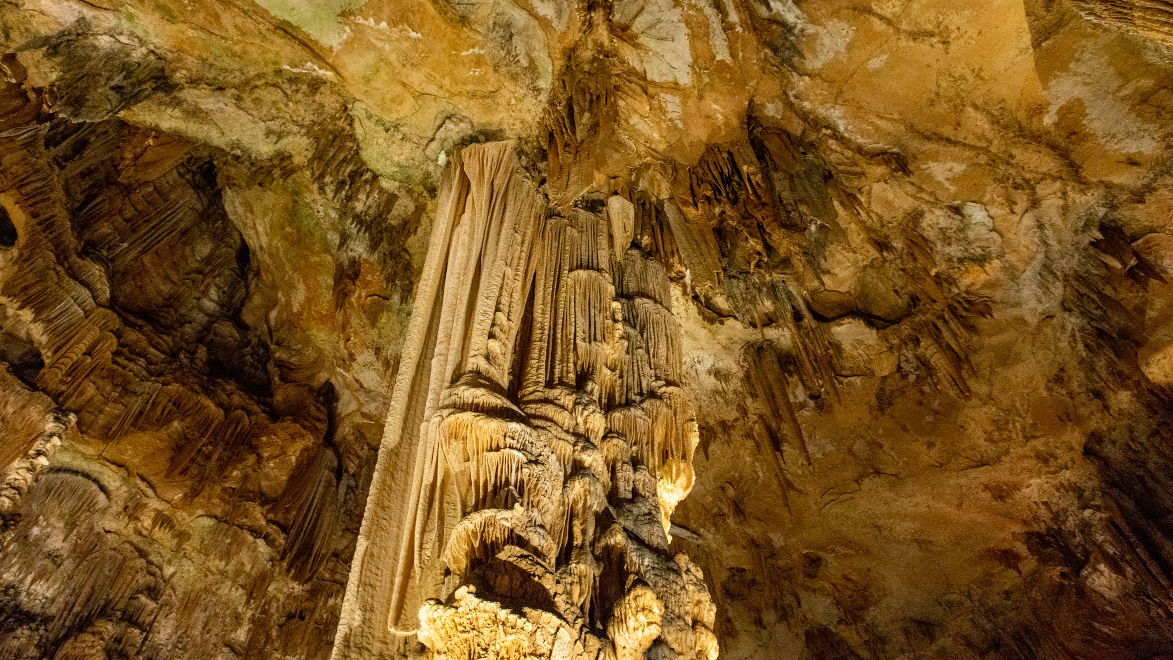 Explore stunning geological formations inside a natural cave with stalactites and stalagmites.