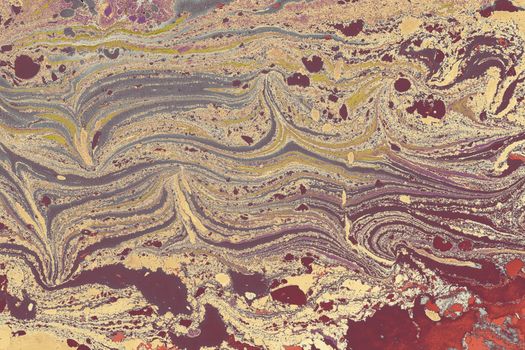 A complex abstract marbled pattern featuring earth tones with fluid swirling lines and textures.