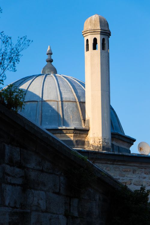 Free A striking minaret and dome rise elegantly against a clear blue sky, exemplifying Islamic architecture. Stock Photo
