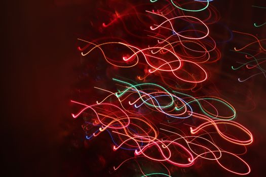 Abstract long exposure photograph showcasing vibrant colored lights in swirling patterns.