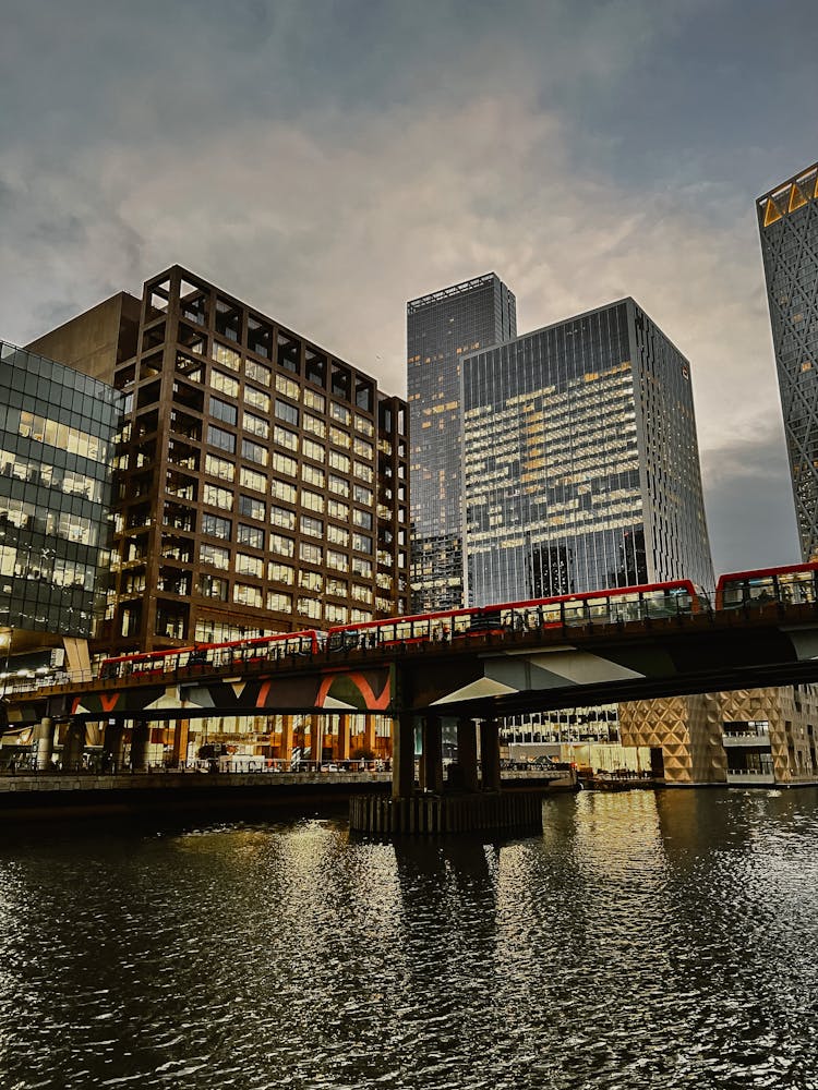 A Railway Over The River Near City Buildings