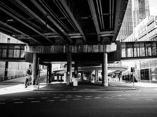 Free An empty urban street with overpasses in striking black and white, showcasing modern architecture. Stock Photo