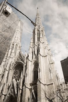 Gothic Revival style of St. Patrick's Cathedral in NYC against the skyline.