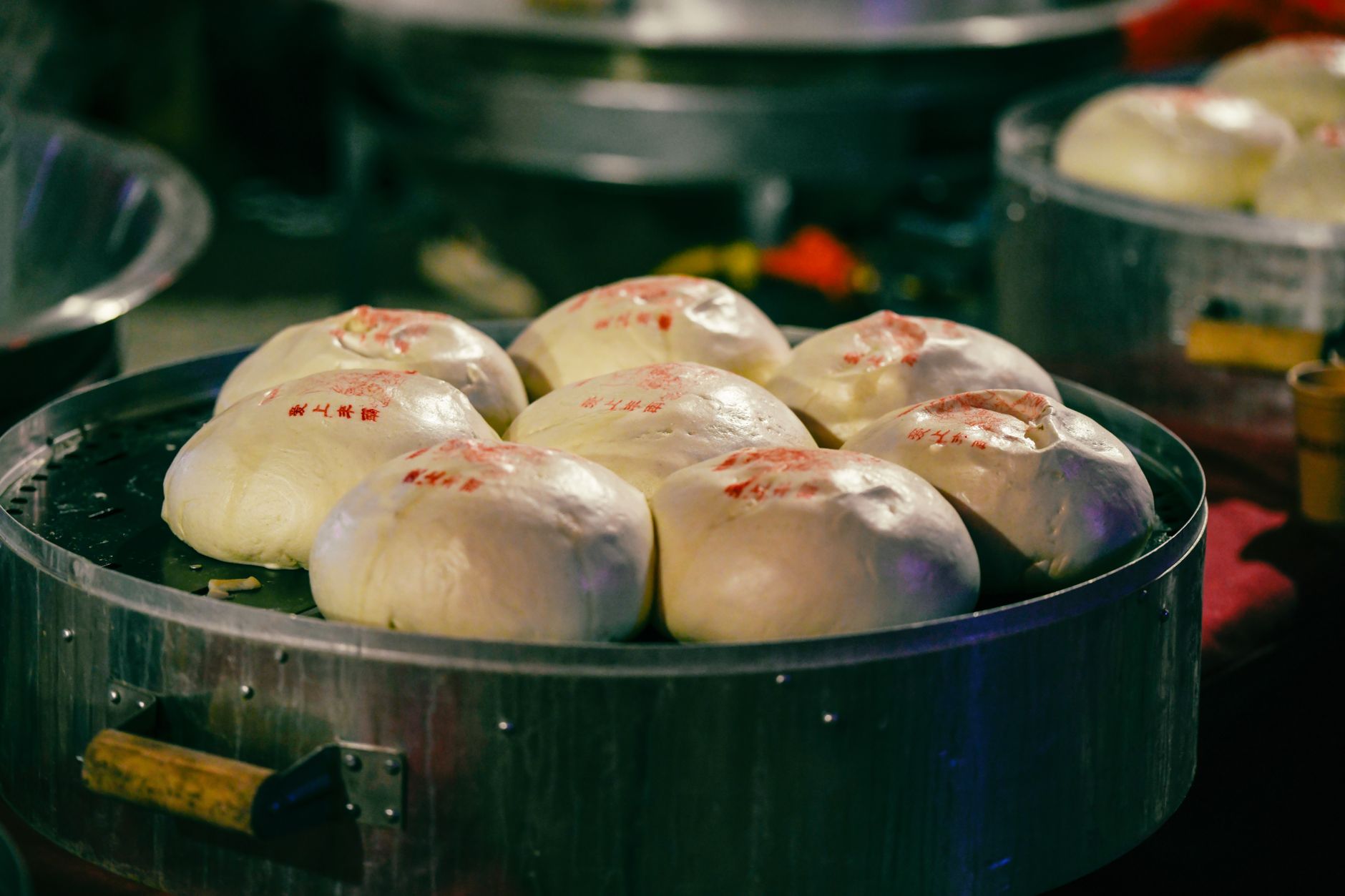 Close-up of delicious steamed buns with unique red markings, showcasing traditional Asian cuisine.