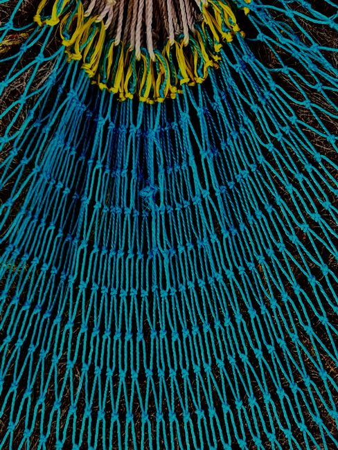 Close-up of a colorful hand-woven hammock texture showing the weave pattern