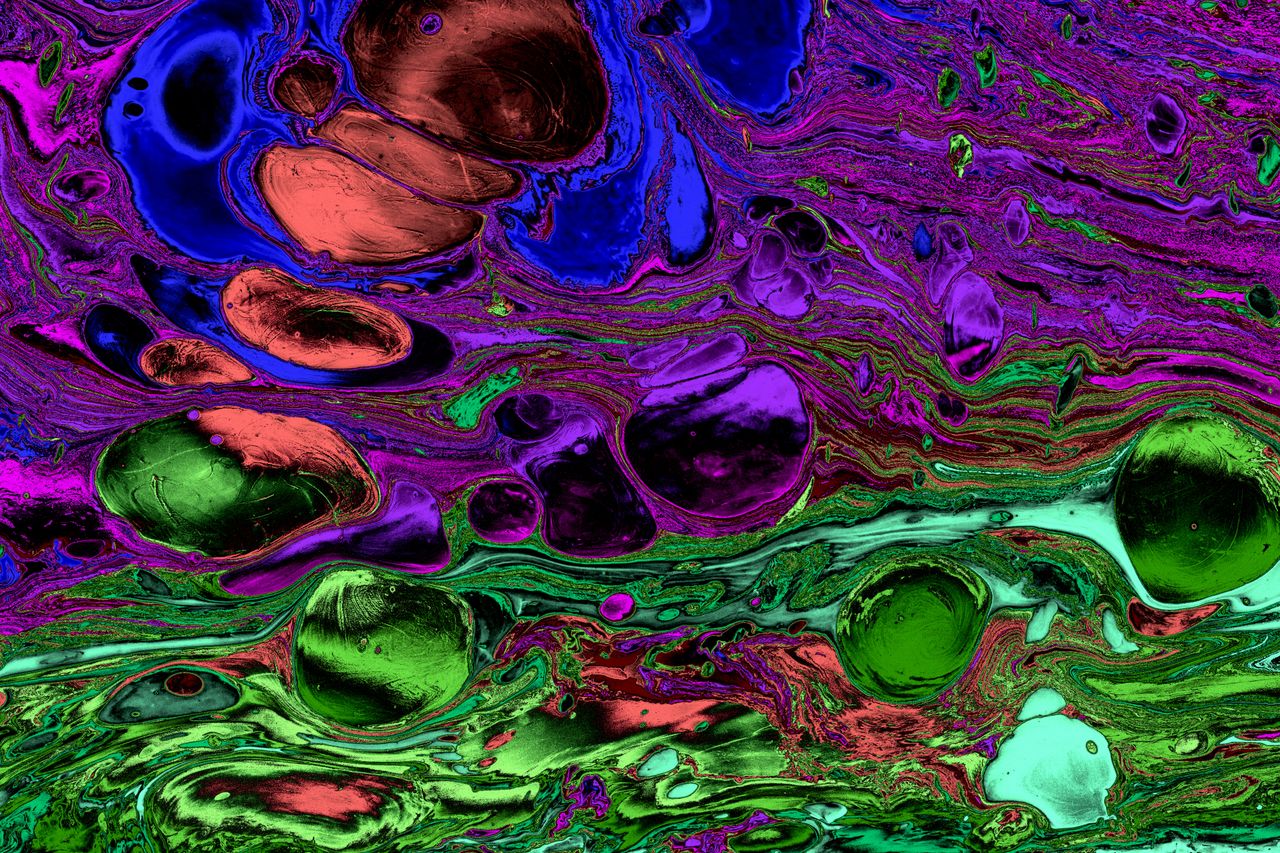 colorful abstract marbling with vibrant swirls of purple blue and gree
