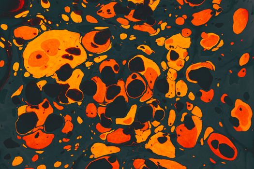 Dynamic abstract fluid art featuring bold orange and black colors with swirling patterns.