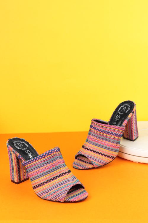 Close-up of Colorful Heels Standing on Yellow Background 