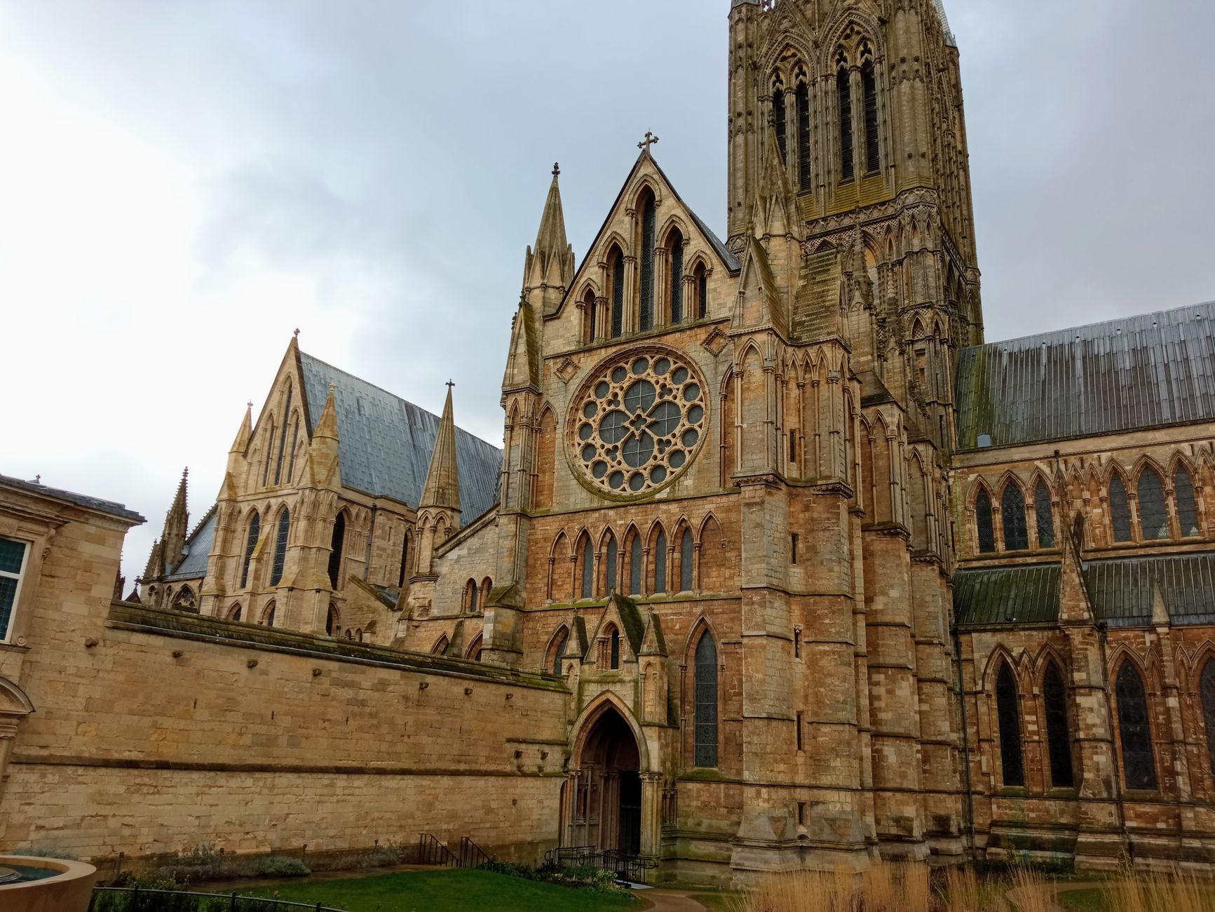 Lincoln Cathedral's Gothic facade rising above the medieval city under an overcast sky