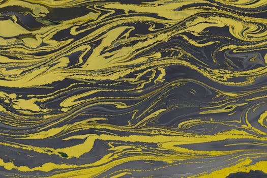 Vibrant yellow and black marbled abstract pattern, perfect for creative backgrounds or artistic projects.