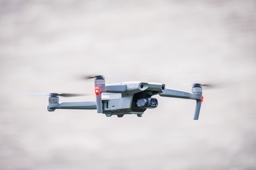 Free A sleek drone flies through the sky, showcasing modern aerial technology. Stock Photo