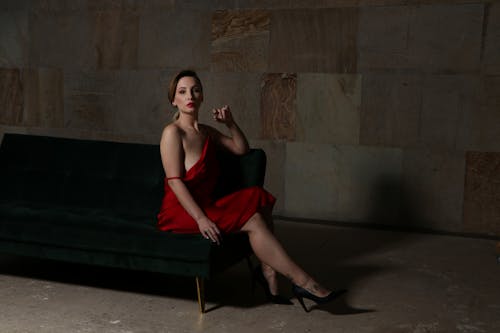 Sensual Woman Sitting on Sofa