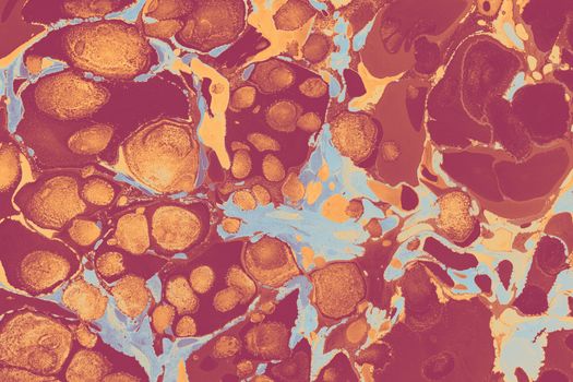 Vibrant abstract marbling art with orange, blue, and red swirls and dots.
