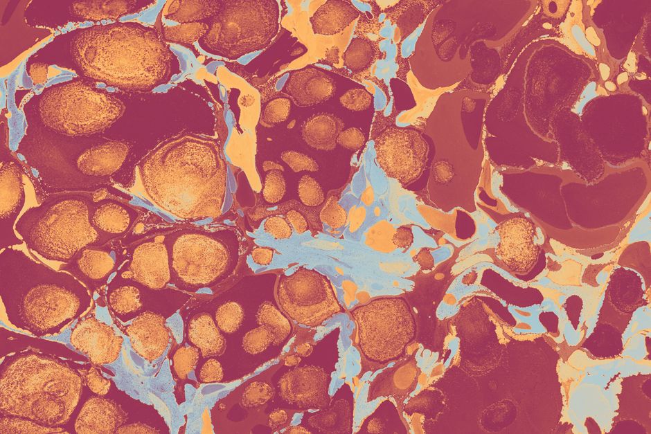 Vibrant abstract marbling art with orange, blue, and red swirls and dots.