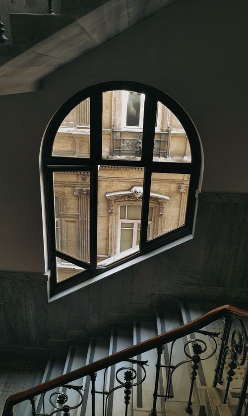 Free A view of a historic building through a mansion's ornate staircase window in Istanbul. Stock Photo