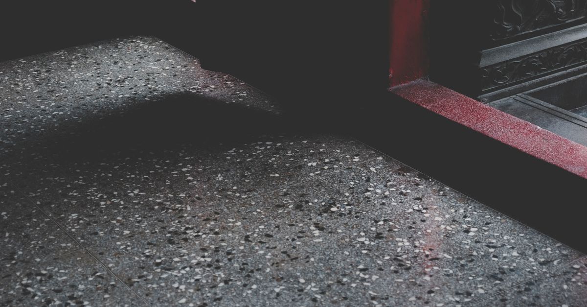Close-up of a moody stone floor with shadows and texture in a Taiwanese building.