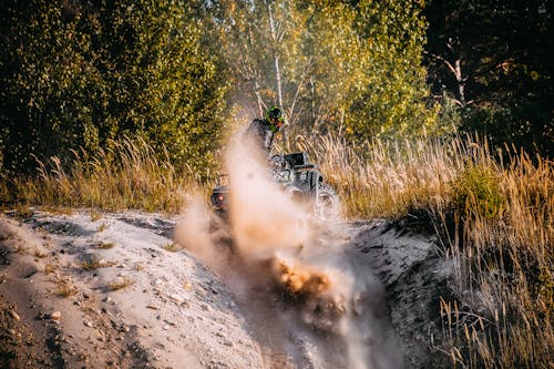 A man riding a dirt bike through the woods