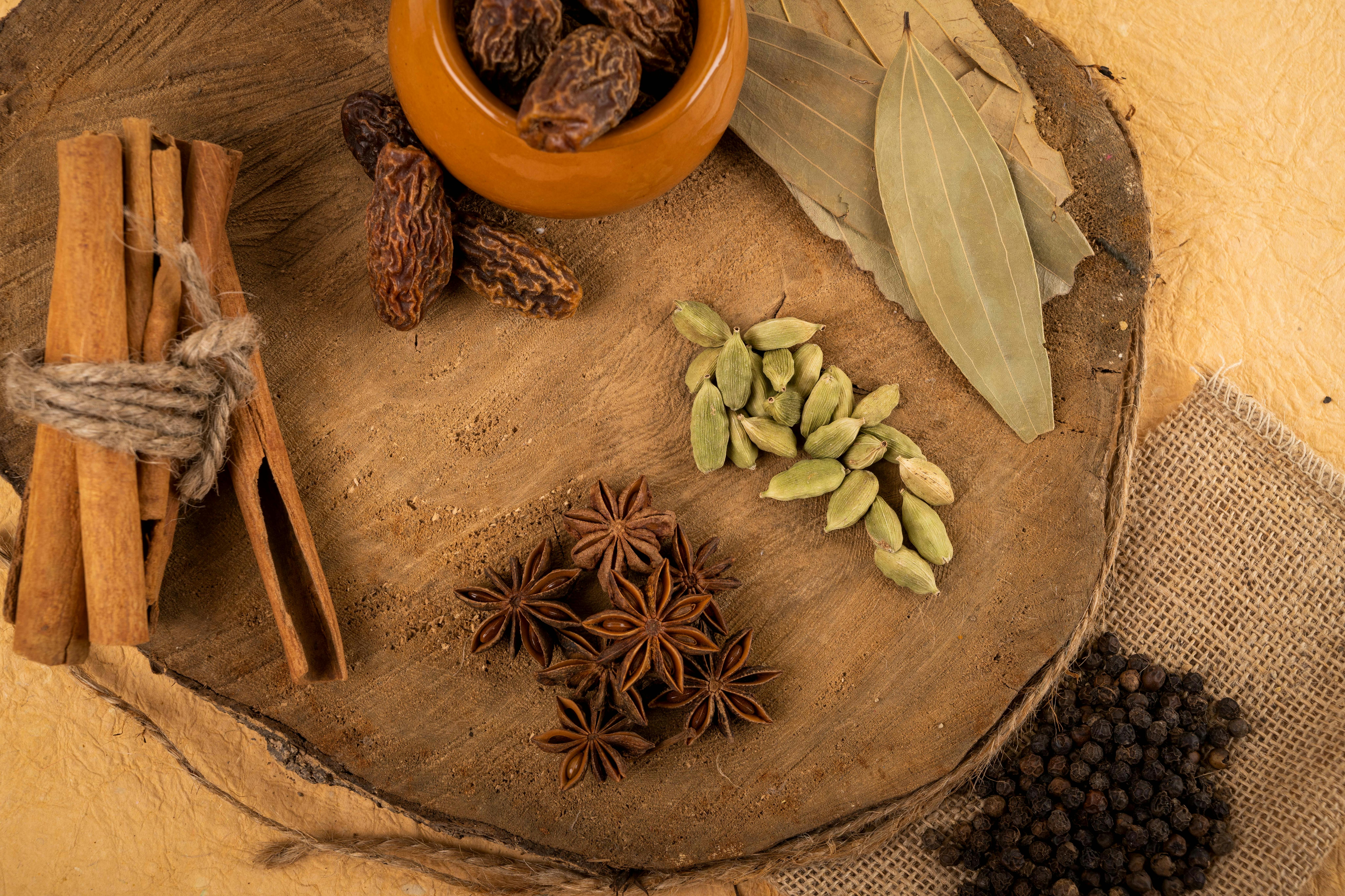 Assortment of whole fresh Indian spices including cardamom, cinnamon sticks, and star anise - fresh Indian spices