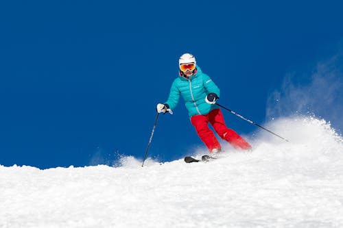 Skier riding a Snowboard