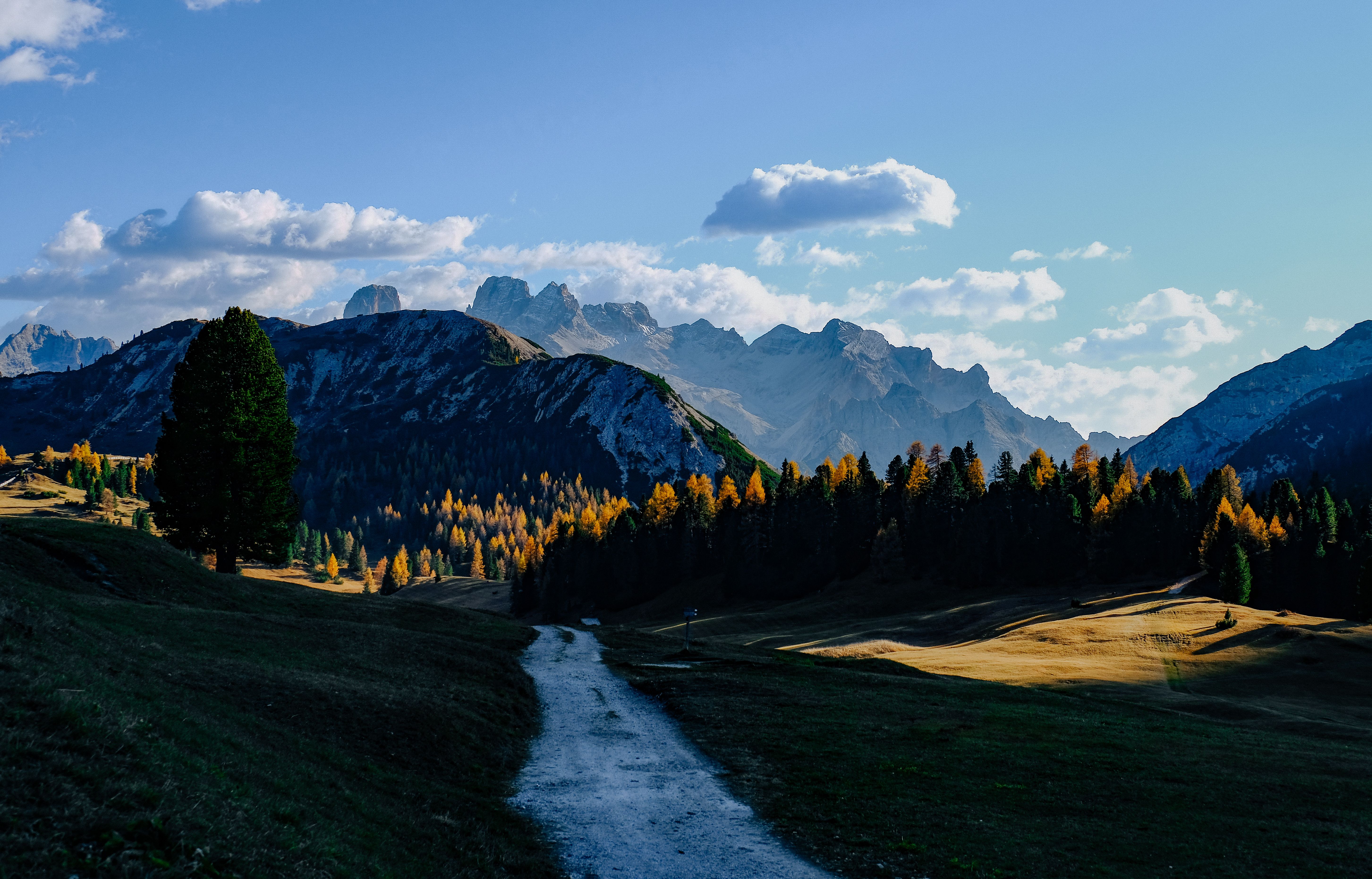 Picturesque view of the Dolomites with a scenic pathway in Dobbiaco, Italy.