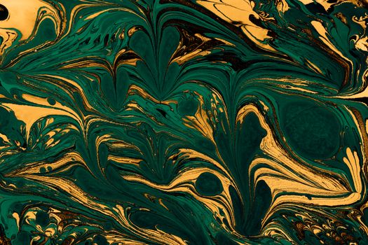 A vibrant abstract artwork featuring green and gold swirling marble patterns.