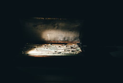 A vintage toolbox with various tools illuminated by sunlight. Captured indoors in Türkiye.