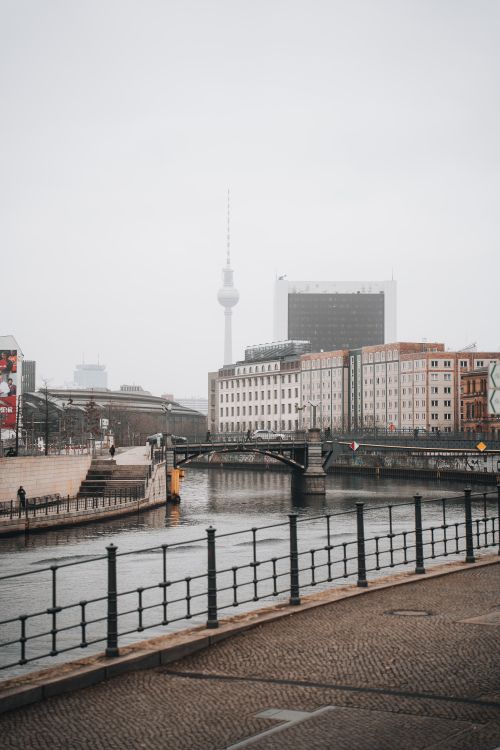 Free A serene view of Berlin with the iconic TV Tower and Spree River showcasing modern architecture and urban life. Stock Photo