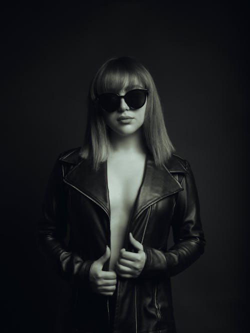 Shirtless Woman in Shades and Black Leather Jacket