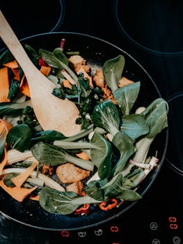 Colorful stir-fry with fresh vegetables in a frying pan. Perfect for healthy cooking inspiration.